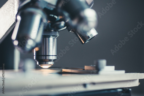 Close-up shot of microscope with metal lens at laboratory.
