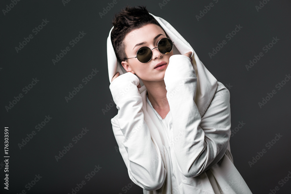 Portrait of a beautiful young girl wearing a white coat and sunglasses Portrait of a beautiful young girl wearing a white coat and sunglasses