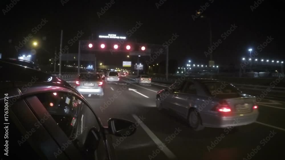 Car is moving on the second line in the city on the highway at night. Car is moving on the second line in the city on the highway at night.