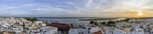 Sunset aerial cityscape in Olhao, Algarve fishing village view of ancient neighbourhood of Barreta, and its traditional cubist architecture. © Carlos Neto