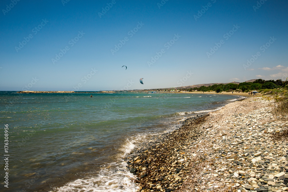 People enjoy kitesurfing rides on Aluminos beach near Larnaca