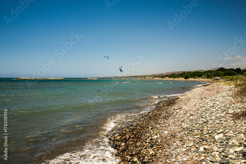 Obraz na płótnie People enjoy kitesurfing rides on Aluminos beach near Larnaca w salonie