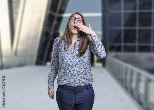 Pretty business woman making sleep gesture.