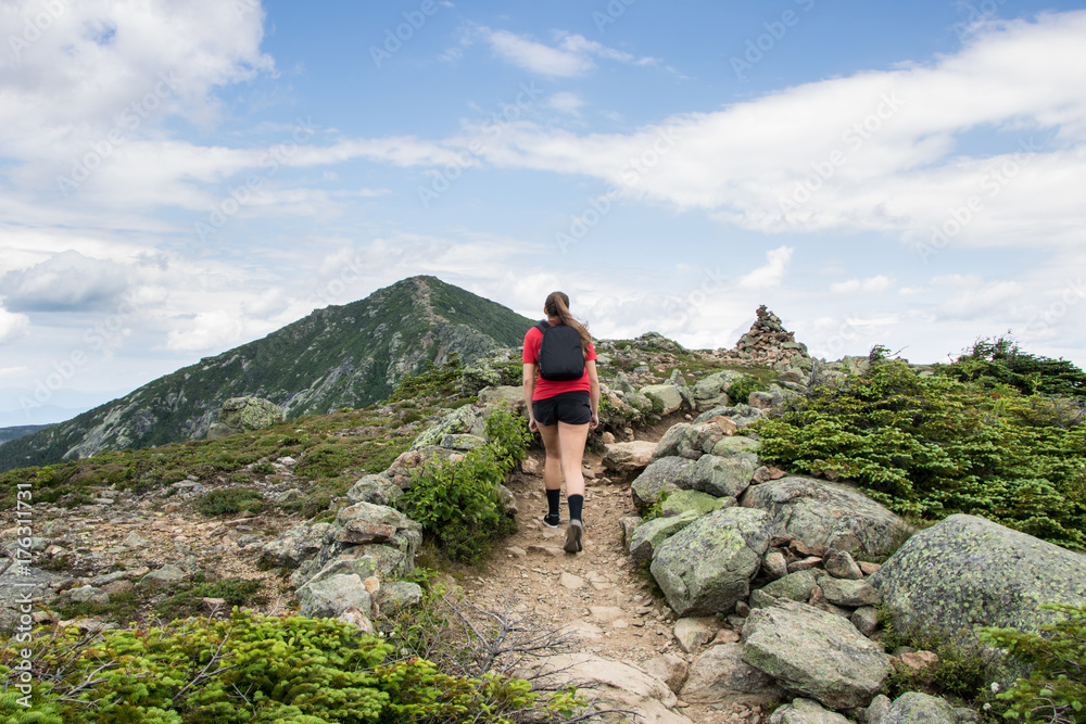Teenage girl hiking on a beautiful mountain 
