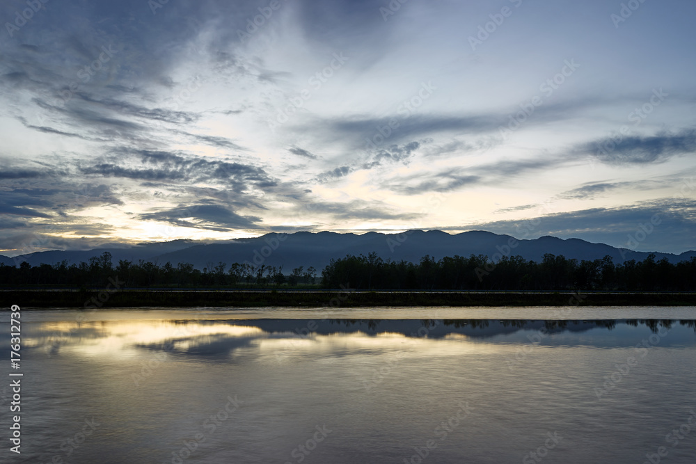 nature scene, sky, clouds, mountain, water and reflection at the morning when sunrise.