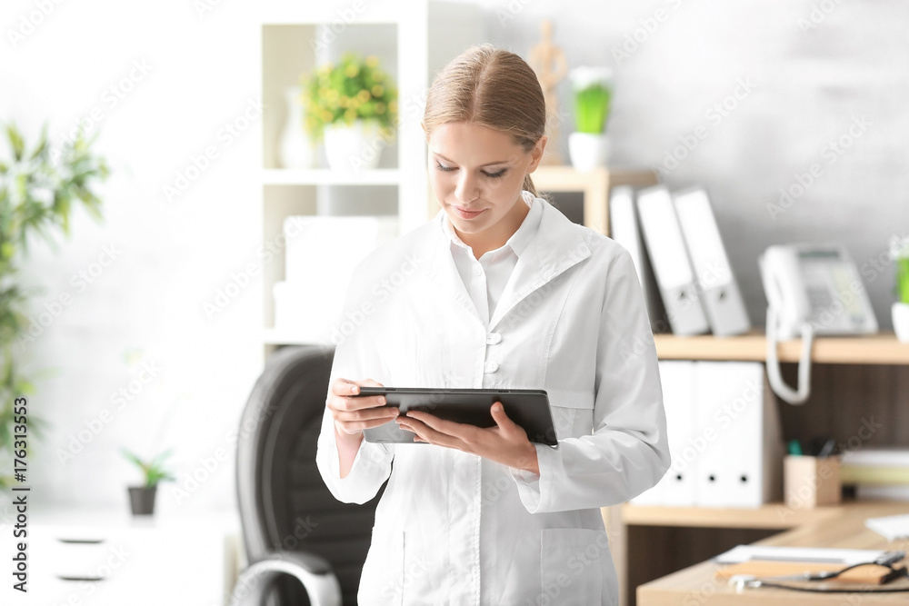 Young female receptionist holding tablet computer in hospital Young female receptionist holding tablet computer in hospital