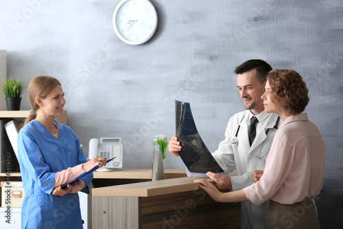 Receptionist and doctor wit...