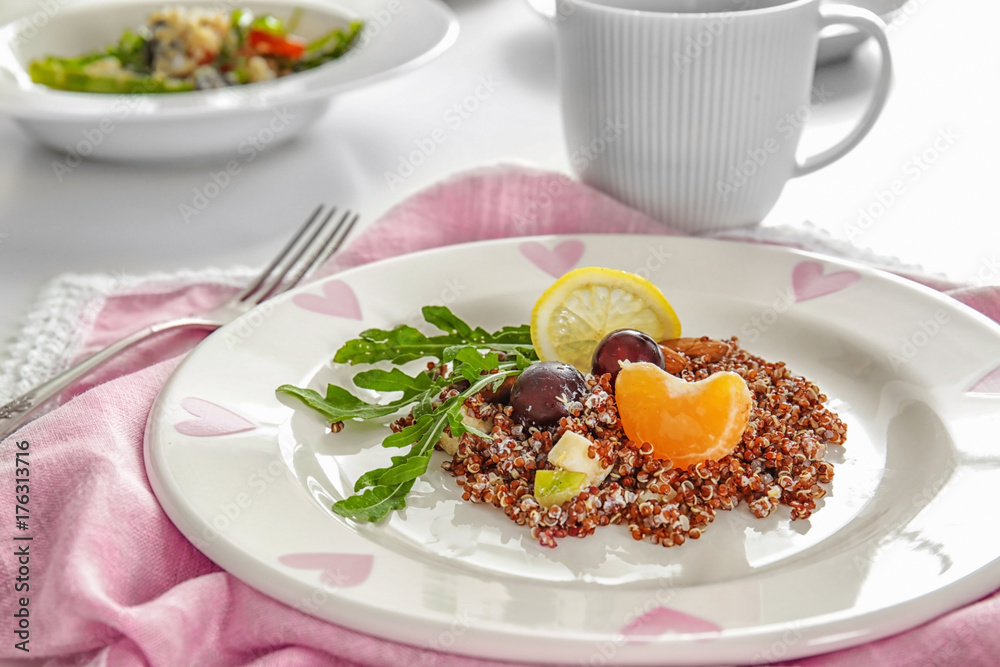 Plate with quinoa and fruits on table, closeup Plate with quinoa and fruits on table, closeup