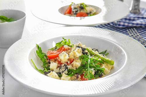 Plate with quinoa salad on table  closeup