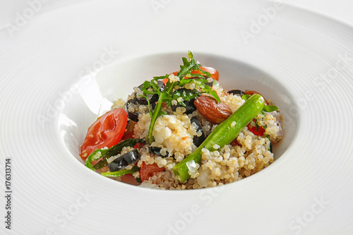 Salad with quinoa and vegetables on plate, closeup