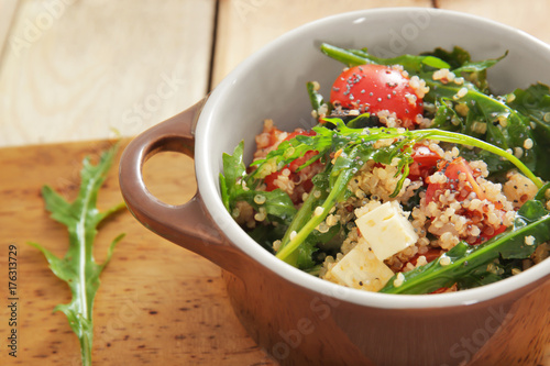 Salad with quinoa and vegetables in casserole on table