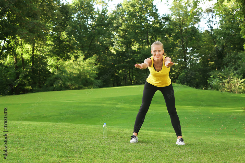 Young sporty woman doing exercise in green park Young sporty woman doing exercise in green park