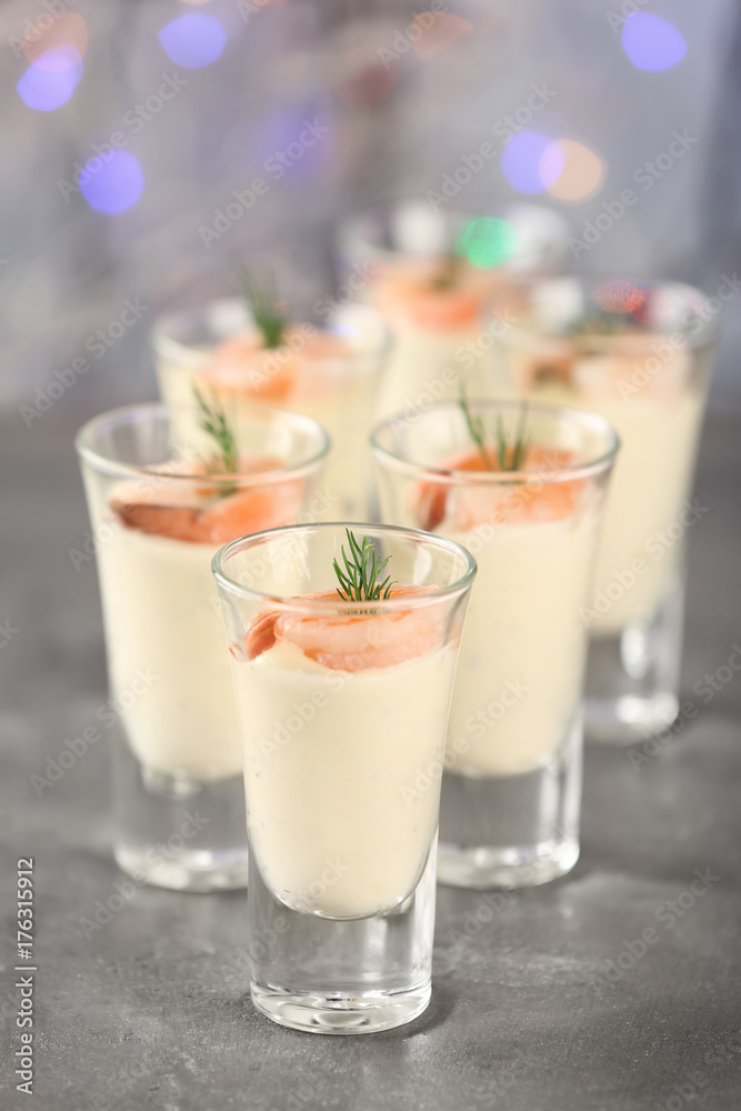 Glasses of white sauce and shrimps on table against sparkly background, closeup Glasses of white sauce and shrimps on table against sparkly background, closeup