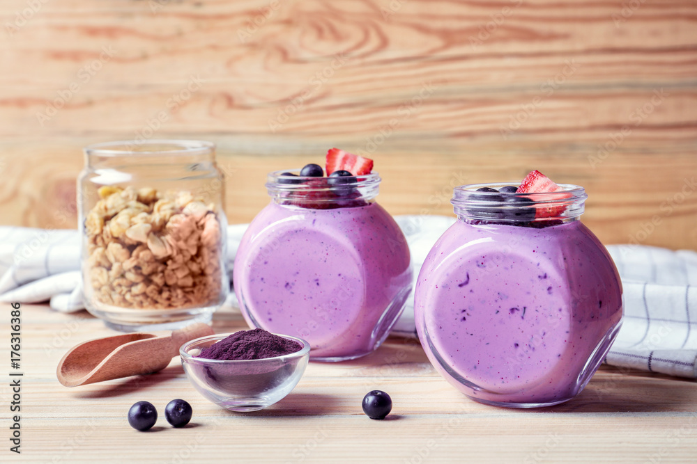 Delicious acai smoothie in jars on table Delicious acai smoothie in jars on table