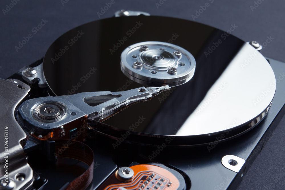 A close-up, the reading head is called a mirrored magnetic disk. The concept of losing digital data on a computer. A close-up, the reading head is called a mirrored magnetic disk. The concept of losing digital data on a computer.