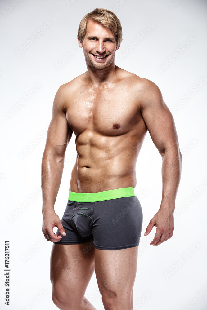 Strong Athletic Man  showing big biceps and abdominal muscles