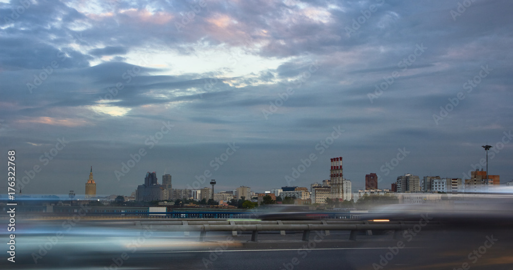 Automobile traffic on a city street at sunset