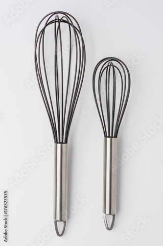 Two Whisks on White Background Top View