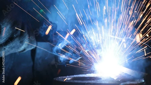 Welding on an industrial plant. Industrial Robot arm active in factory. Automation welding mechanical procedure. Close up