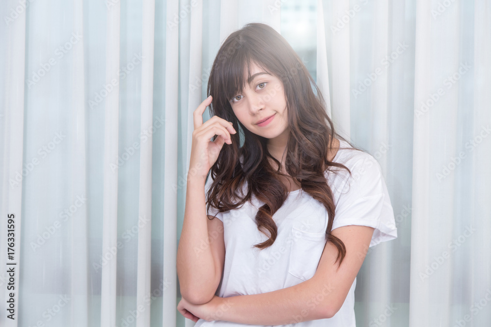 Portrait of a beautiful young woman thinking on her bedroom. Portrait of a beautiful young woman thinking on her bedroom.