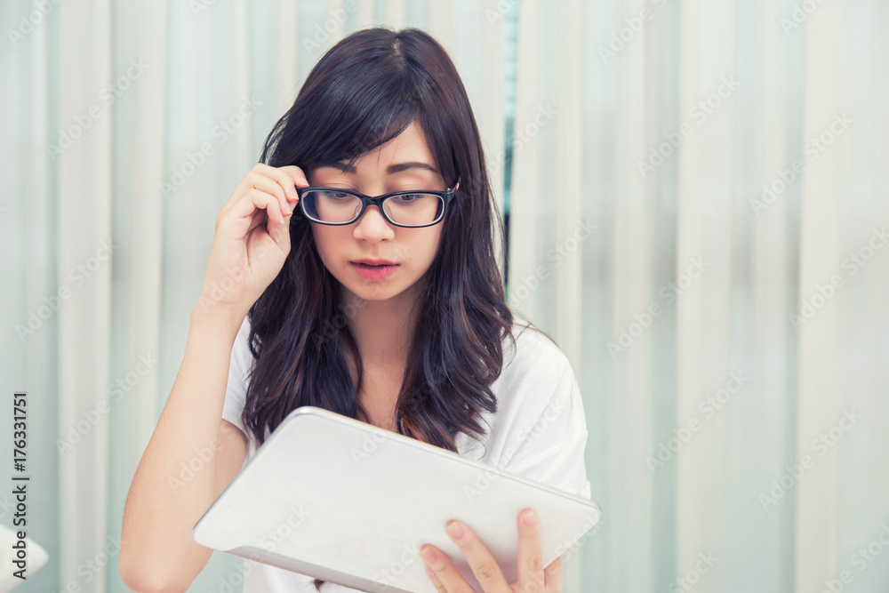 young woman reading massage from pad at her bedroom. concept fot business young woman reading massage from pad at her bedroom. concept fot business