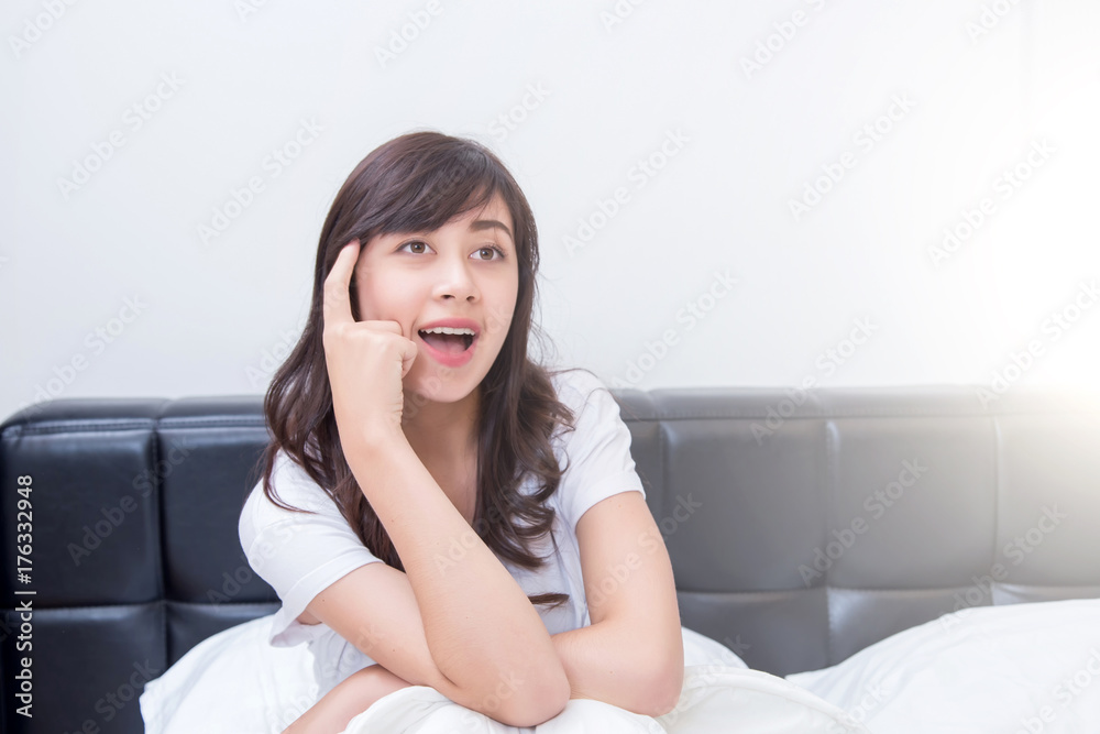 Portrait of a beautiful young woman thinking on her bedroom. Portrait of a beautiful young woman thinking on her bedroom.
