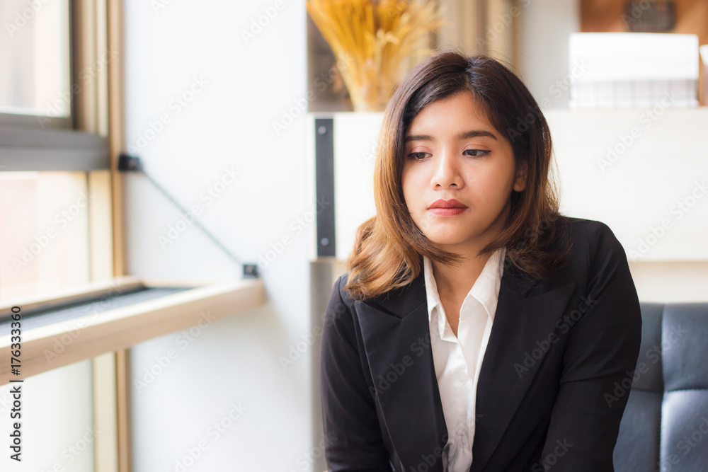 A beautiful asian business woman sitting relaxing on sofa and thinking something in coffee shop. A beautiful asian business woman sitting relaxing on sofa and thinking something in coffee shop.