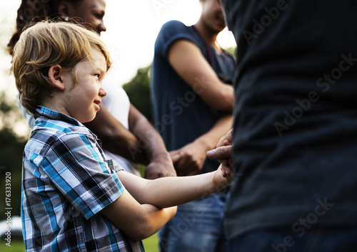 Group of people holding hand together in the park