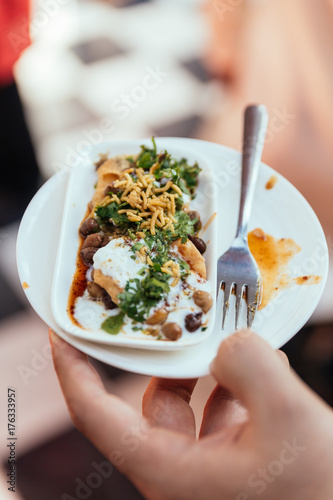 Papri Chaat is traditionally prepared using crisp fried dough wafers known as papri, along with boiled chick peas, boiled potatoes, yogurt and tamarind chutney and topped with chaat masala and sev.