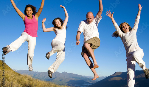 Group of young people jumping in the field Concept photo