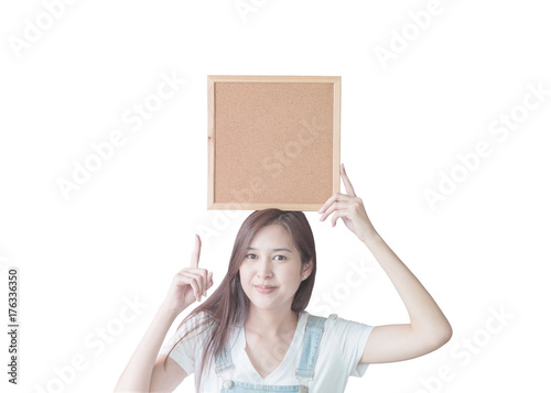 Closeup asian woman with cork board in hand and point to space in cork board isolated on white background with clipping path
