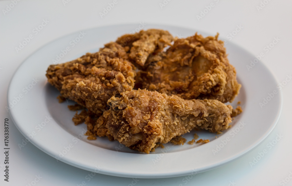 Fried chicken on white plate isolated on white background. Fried chicken on white plate isolated on white background.