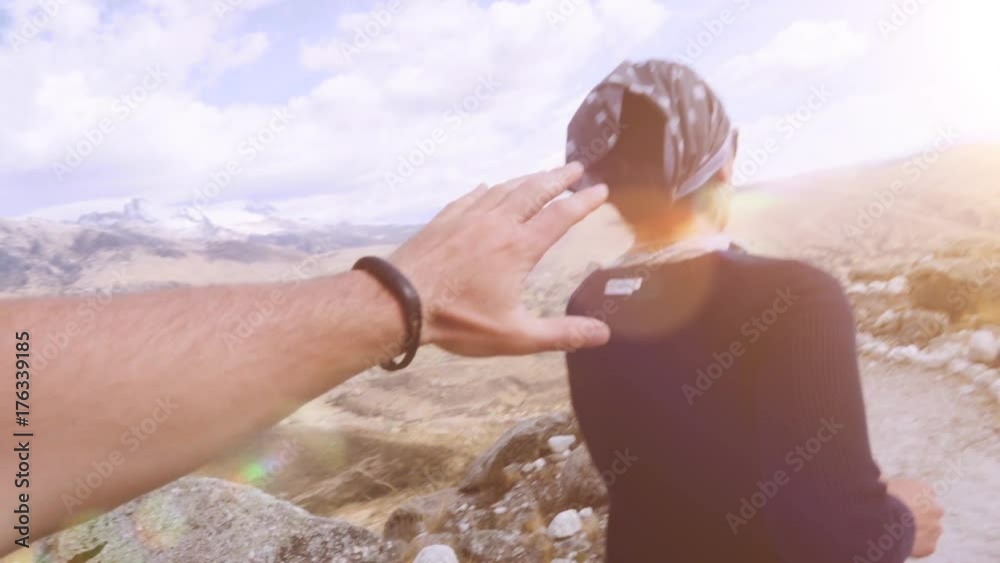 Couple chasing each other and playing happy on the Andean mountains during a trekking of the cordillera blanca. Slow motion	Couple chasing each other on the mountains