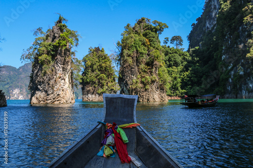 Sightseeing  toursit boat with Three bars stand together in sea (Guilin of Thailand) at Cheow lan lake,Ratchaprapha dam,Suratthani,Thailand.(KHAO SOK National Park ) © NEPTUNESTOCK