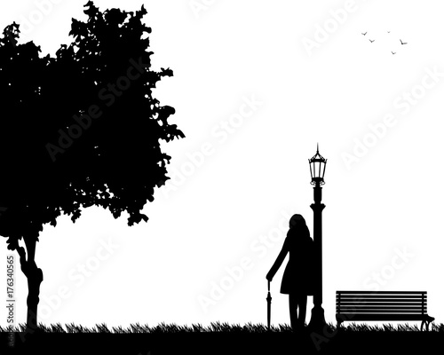 Young sexy girl is standing and waiting for someone with umbrella in park, one in the series of similar images silhouette