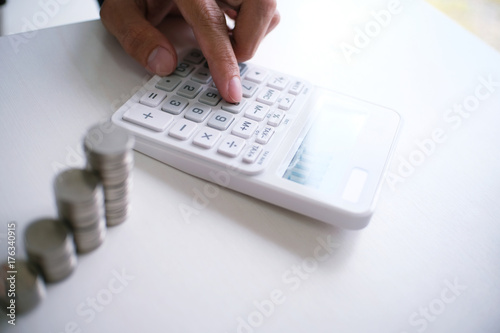 Accountant verify the business and saving money stacking gold coins with calculator. Accountancy Concept