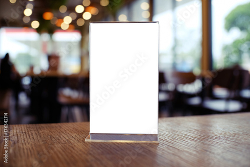 Mock up Menu frame standing on wood table in Bar restaurant cafe. space for text