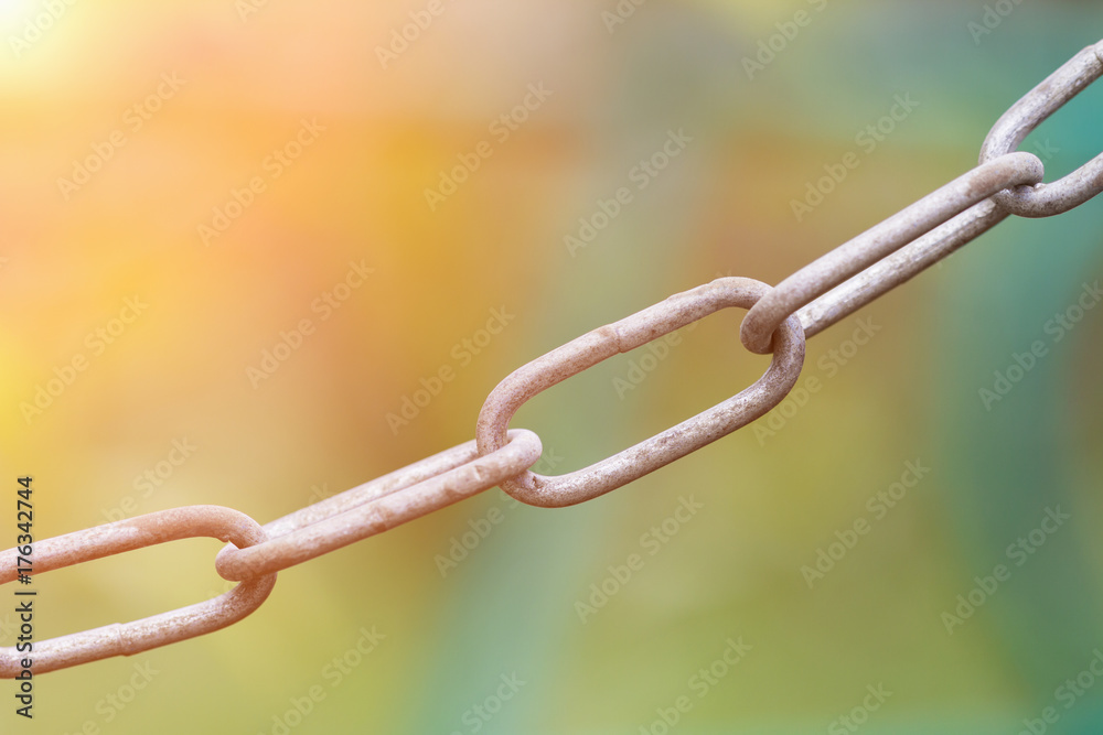 Old rusty metal chain on green background. Selective focus Old rusty metal chain on green background. Selective focus