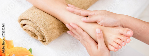 Therapist giving relaxing reflexology Thai foot massage treatment to a woman in spa © Atstock Productions