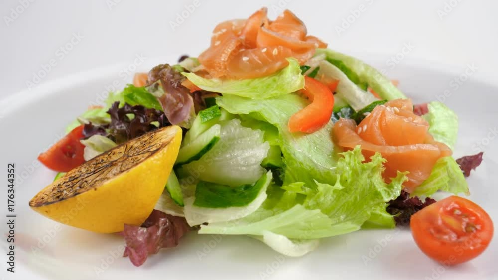 Smoked salmon salad, served with cherry tomatoes, sesame seed, cucumber and bell pepper, served in restaurant, loop, 4K, ProRes codec, 422 HQ Smoked salmon salad, served with cherry tomatoes, sesame seed, cucumber and bell pepper, served in restaurant, loop, 4K, ProRes codec, 422 HQ