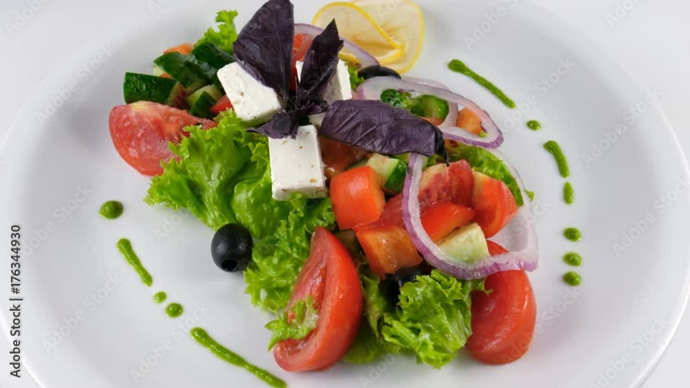 Classic Greek salad served in Restaurant, includes tomatoes, cucumber, bell pepper, feta cheese, red onion and olives, loop, 4K, ProRes codec, 422 HQ Classic Greek salad served in Restaurant, includes tomatoes, cucumber, bell pepper, feta cheese, red onion and olives, loop, 4K, ProRes codec, 422 HQ