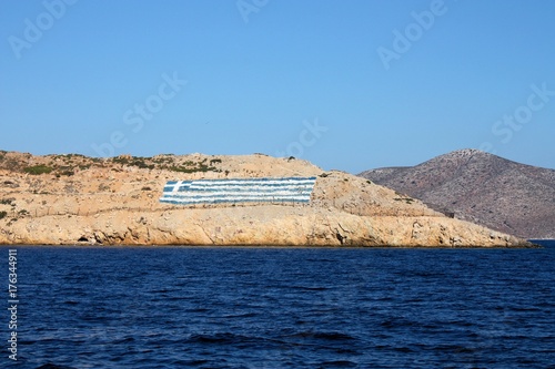 Greece flage surrounded with fance on island in Greece photo