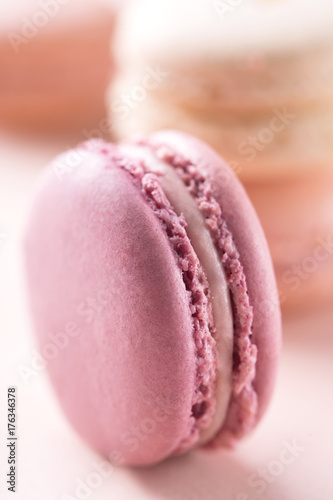 Macaron on a pastel background. Blurred macarons in back. French confectionery. Sweet food