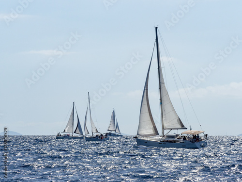 Sailing yacht in Croaatia, windy summer on the boat between rocky islands of the Mediterranean sea © jzajic