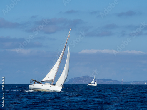 Sailing yacht in Croaatia, windy summer on the boat between rocky islands of the Mediterranean sea