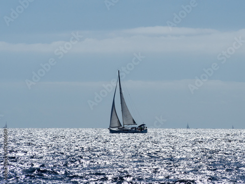 Sailing yacht in Croaatia, windy summer on the boat between rocky islands of the Mediterranean sea © jzajic