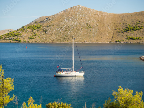 Sailing yacht in Croatia, anchoring in a bay, windy summer on the boat between rocky islands of the Mediterranean sea