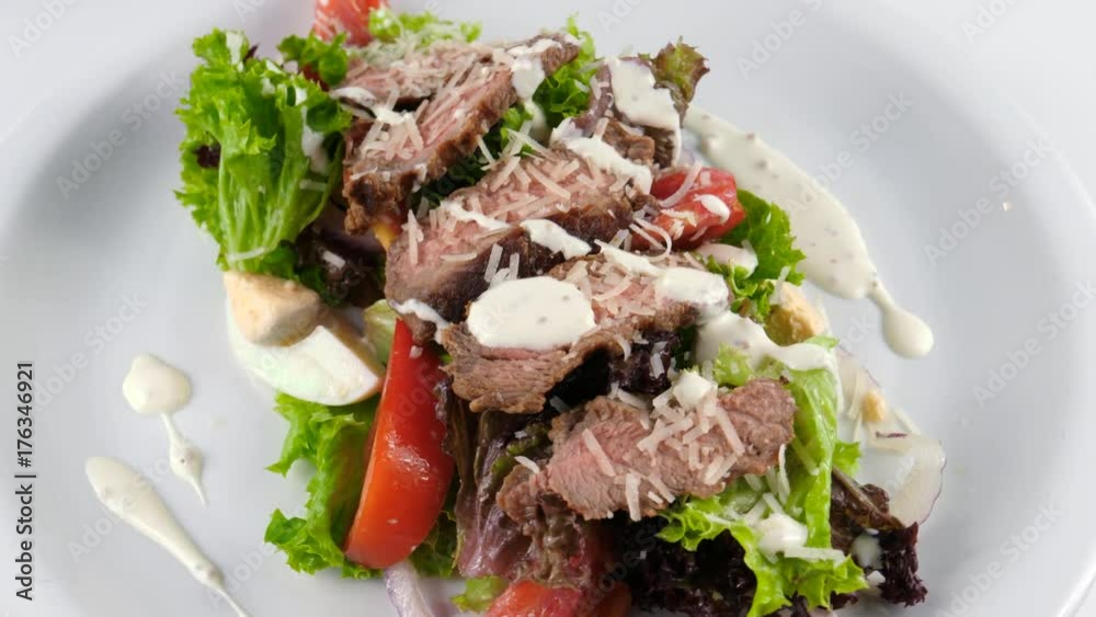Meat salad served in Restaurant, includes roast beef, parmesan cheese, tomatoes, eggs and sauce, loop, 4K, ProRes codec, 422 HQ Meat salad served in Restaurant, includes roast beef, parmesan cheese, tomatoes, eggs and sauce, loop, 4K, ProRes codec, 422 HQ