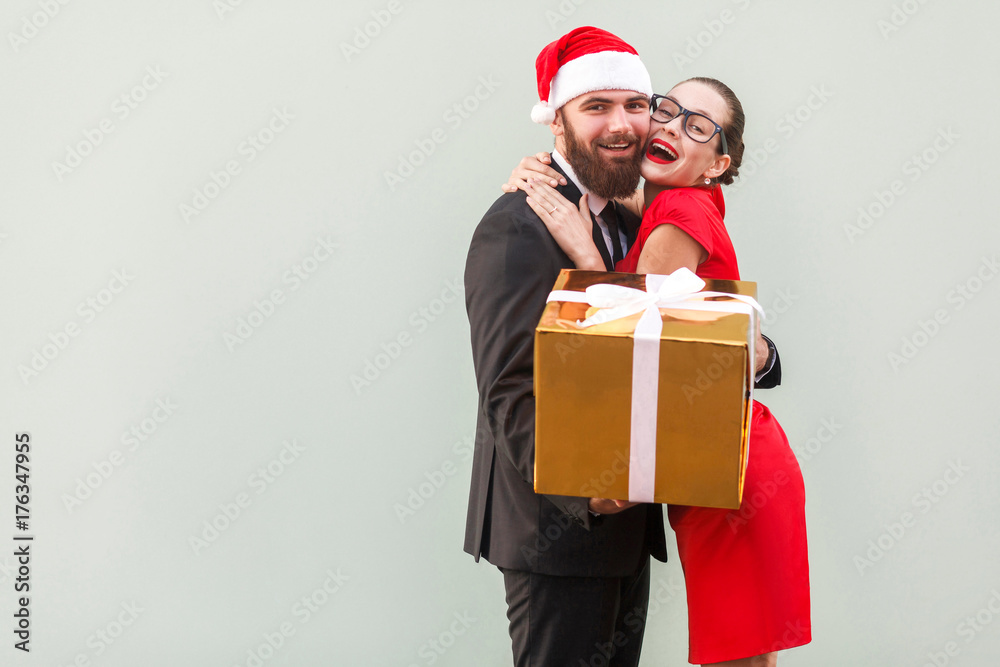 Close up. Love concept. Beautiful girl hugging happy businessman, because he gave a gifts. Close up. Love concept. Beautiful girl hugging happy businessman, because he gave a gifts.