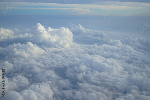 Shades of light blue color sky and constantly change floating white cloud heaven view from airplane window